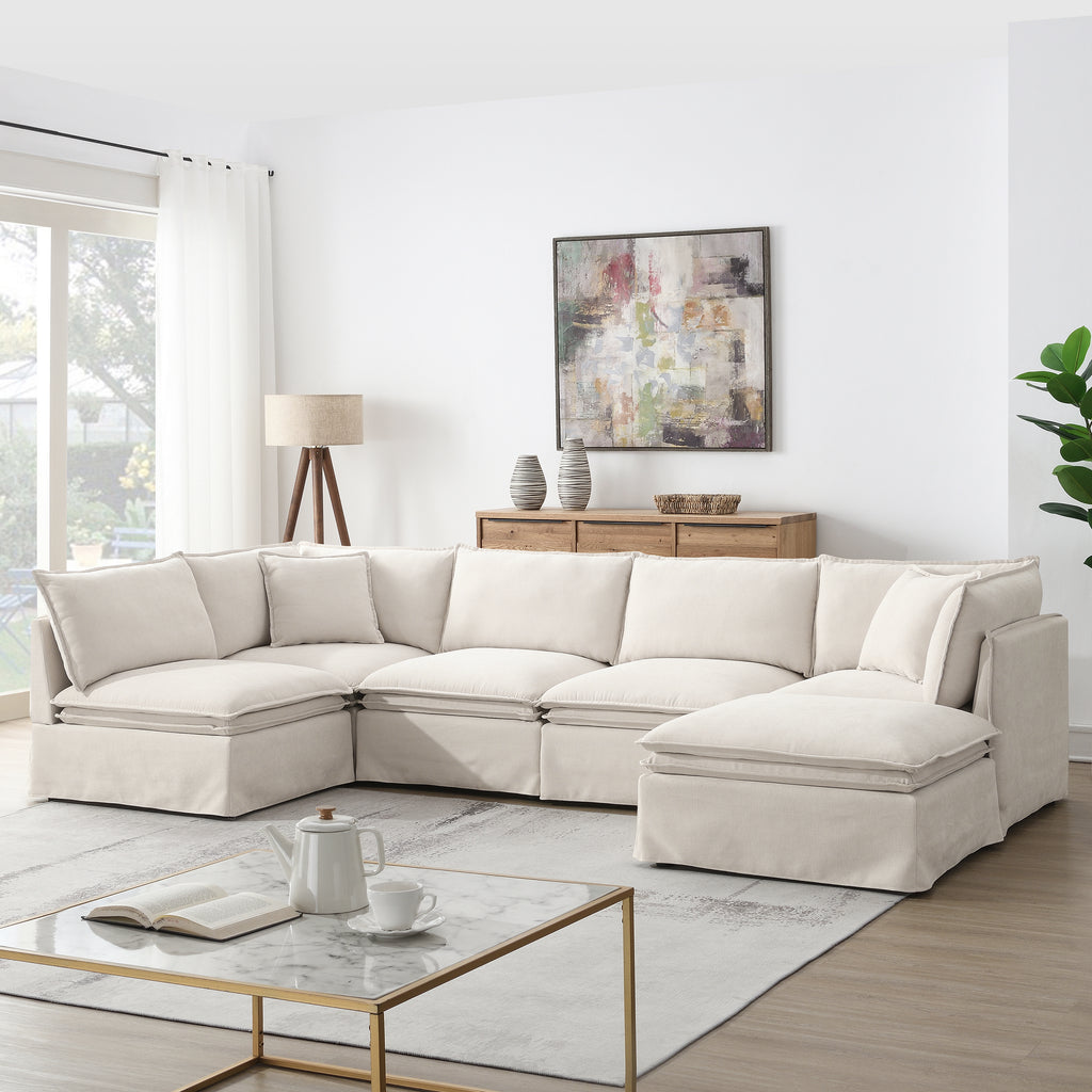 Versatile modular sectional sofa with ottoman arranged in a U-shape, ideal for spacious living rooms and modern interiors.