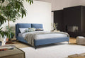 Modern blue upholstered queen bed frame with a sleek, vertical-stitched headboard and slender black metal legs.