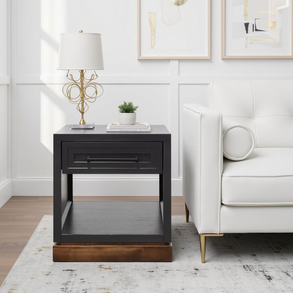 Nora 22 Inch End Table in black and whiskey finish beside white sofa, modern style with drawer and shelf, fully assembled.