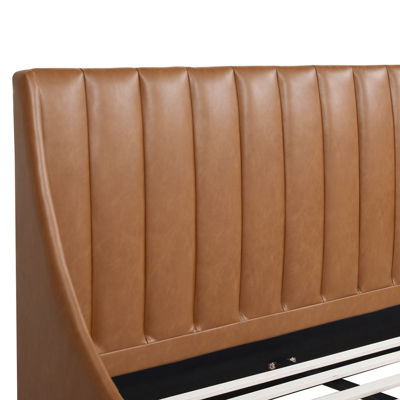 Close-up of vertical tufted detailing on caramel tan faux leather headboard of Aspen king platform bed.