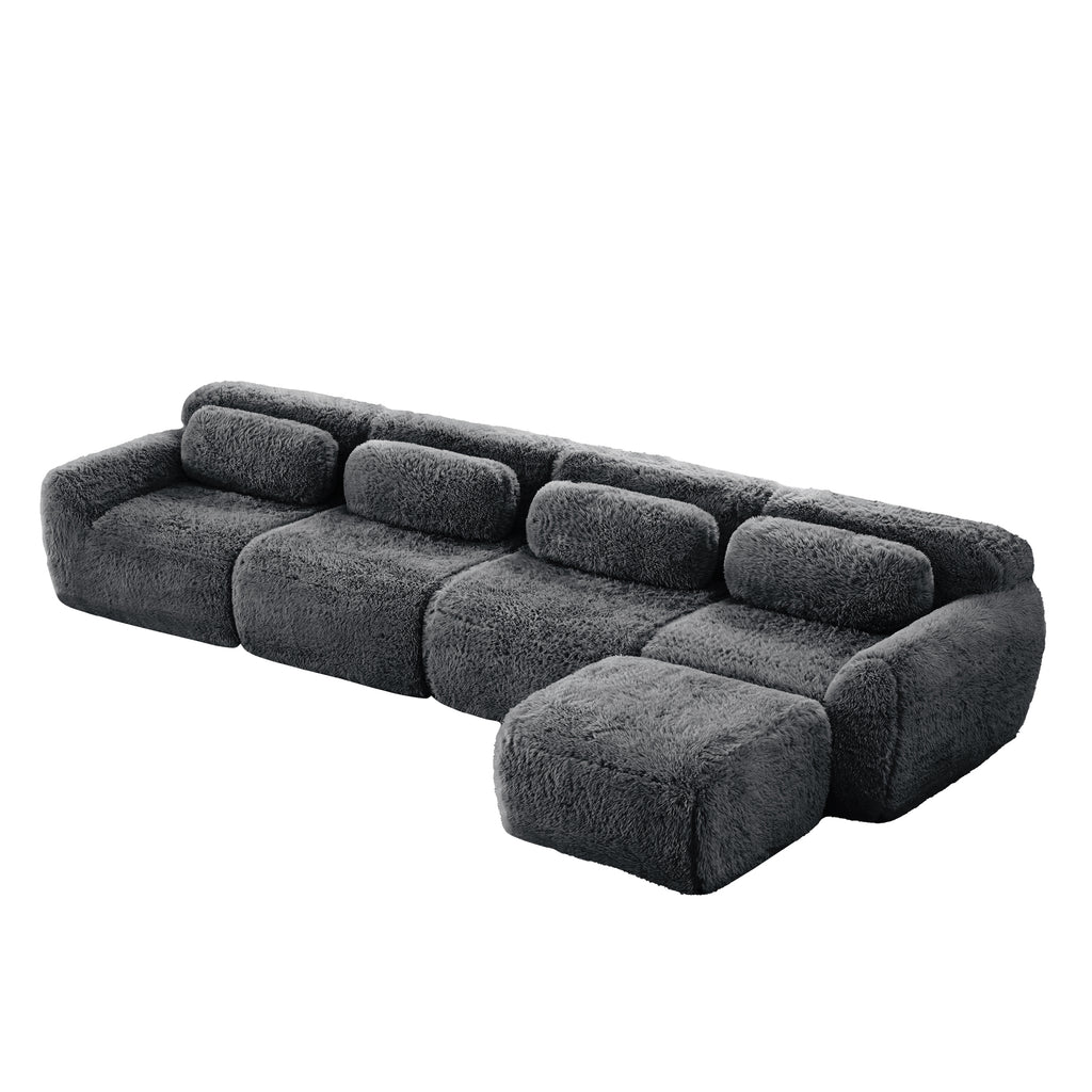 Dark grey sofa - modular sectional plush fabric with movable ottoman. Customizable layout for flexible seating arrangements.
