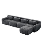 Dark grey sofa - modular sectional plush fabric with movable ottoman. Customizable layout for flexible seating arrangements.