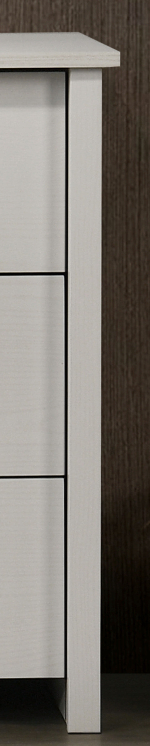 Side panel detail of white 6-drawer dresser showing clean lines and sturdy construction. Perfect for contemporary bedroom storage.