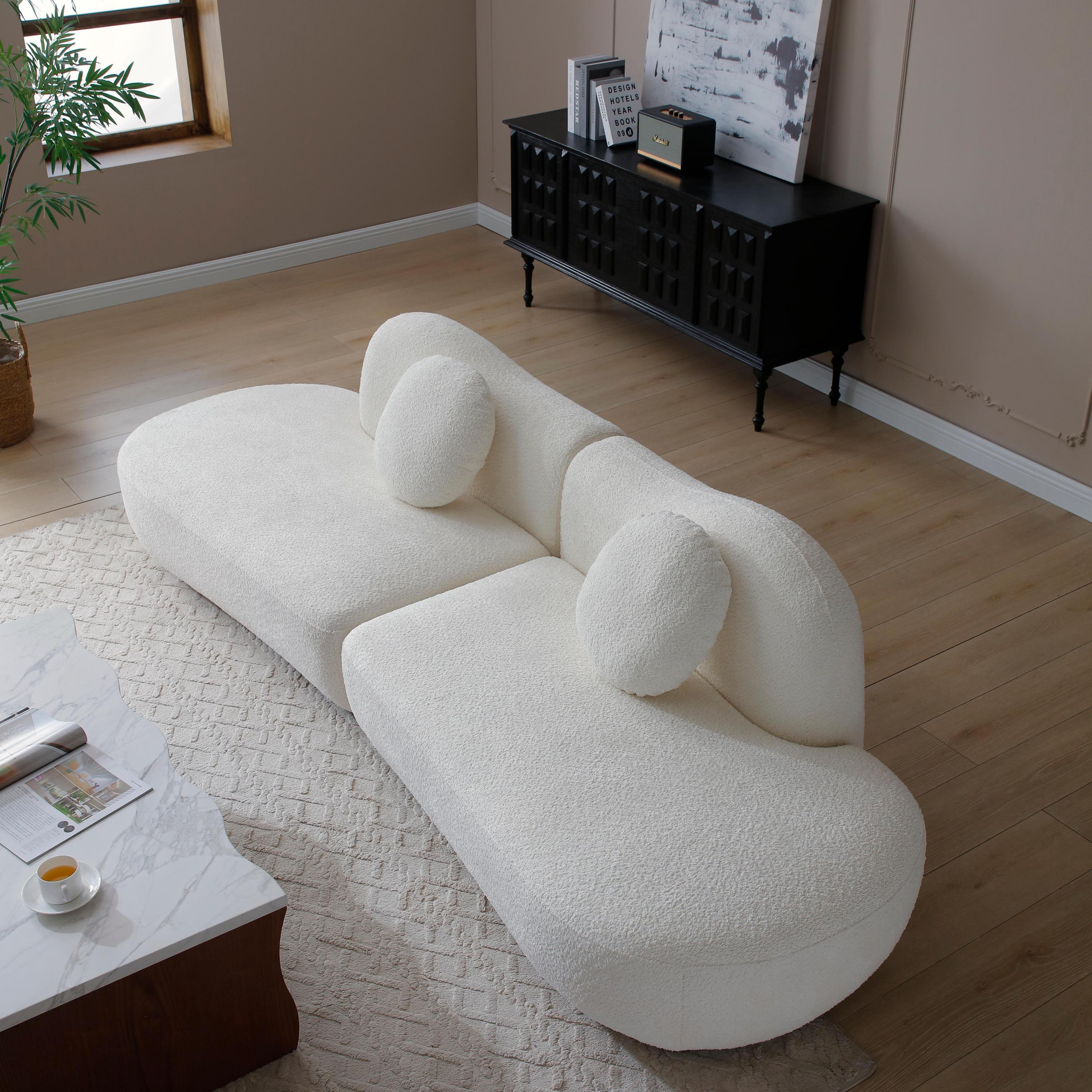Top angled view of modern curved sofa with plush boucle texture, highlighting its modular build and sculptural backrest design.