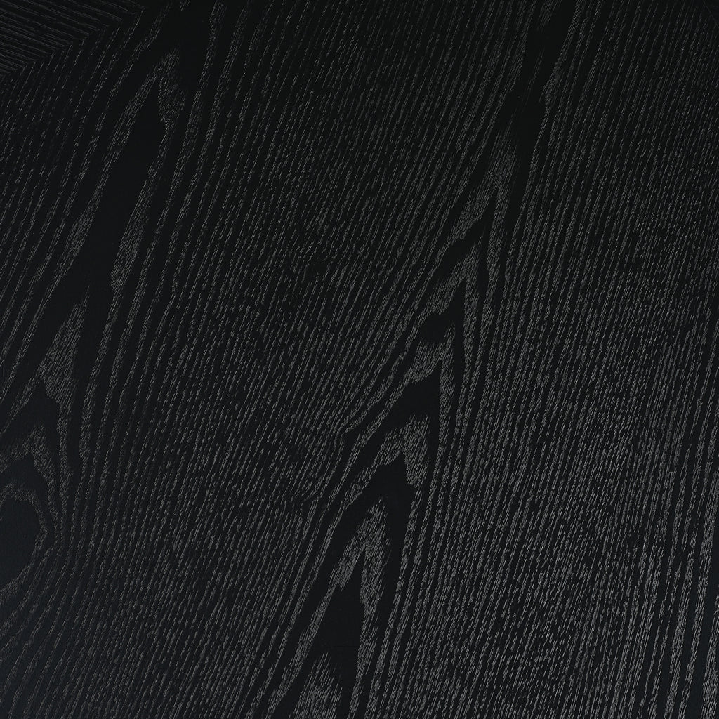 Close-up of black MDF tabletop with visible wood grain texture. Durable and stylish surface for modern dining settings.