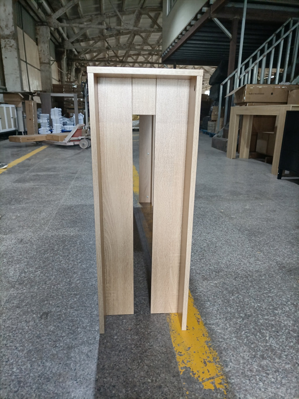 Farmhouse Oak Console Table - Extra-Long Entryway Table side view in warehouse, highlighting durable MDF legs and compact profile.