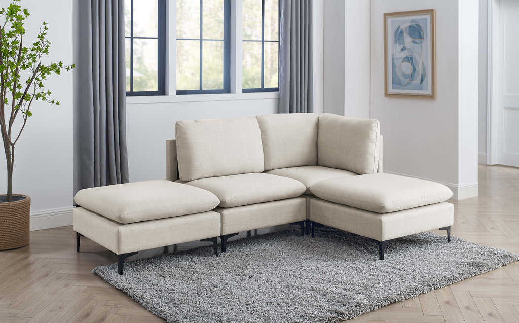 Beige linen modular sectional sofa with plush cushions and sleek black metal legs on a grey shaggy rug.