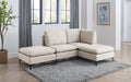 Beige linen modular sectional sofa with plush cushions and sleek black metal legs on a grey shaggy rug.