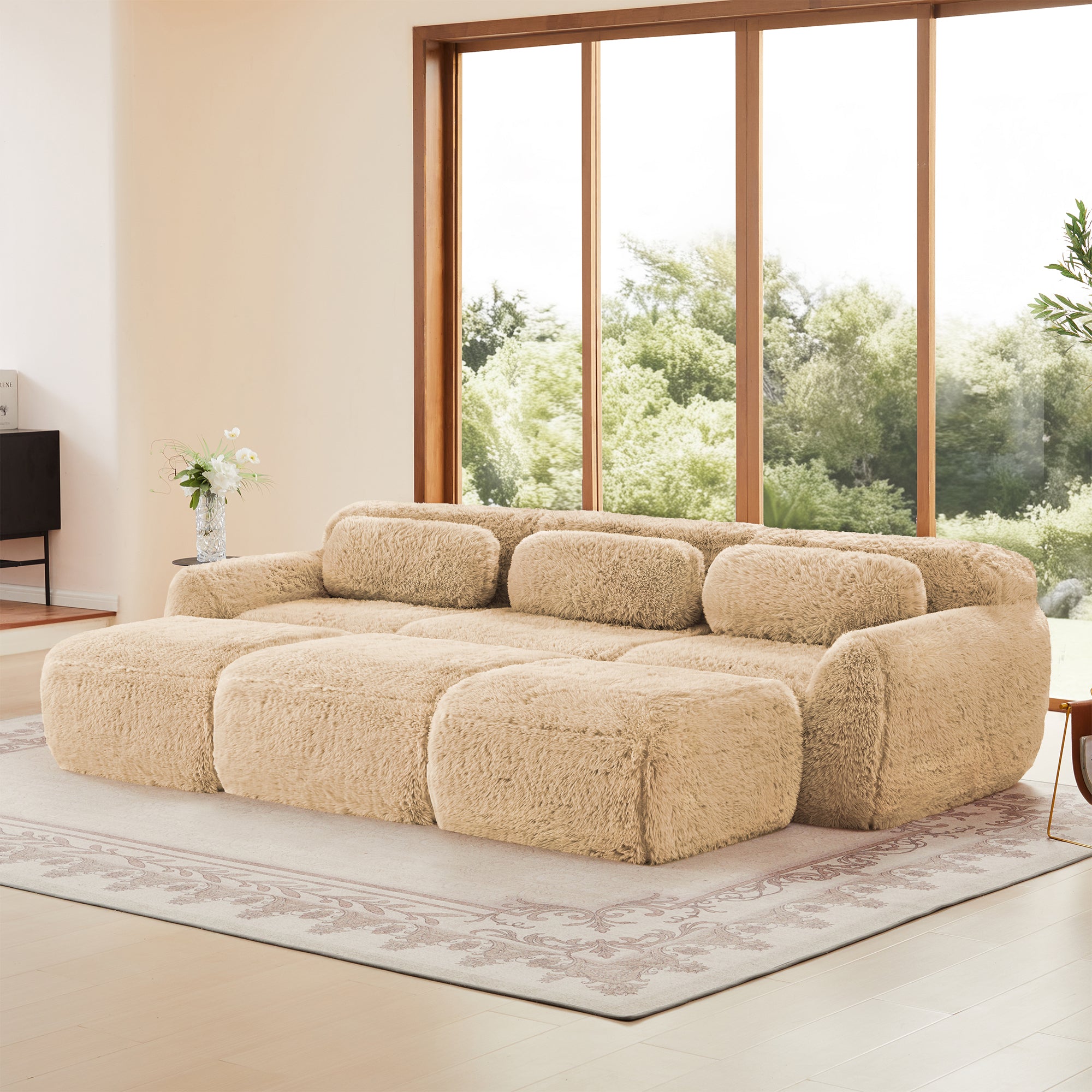 Modular sofa no assembly in light khaki plush fabric, shown in a spacious living room with natural lighting and garden view.