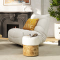 Round ottoman featuring an ivory white bouclé upholstered seat atop a cylindrical natural burl wood base.