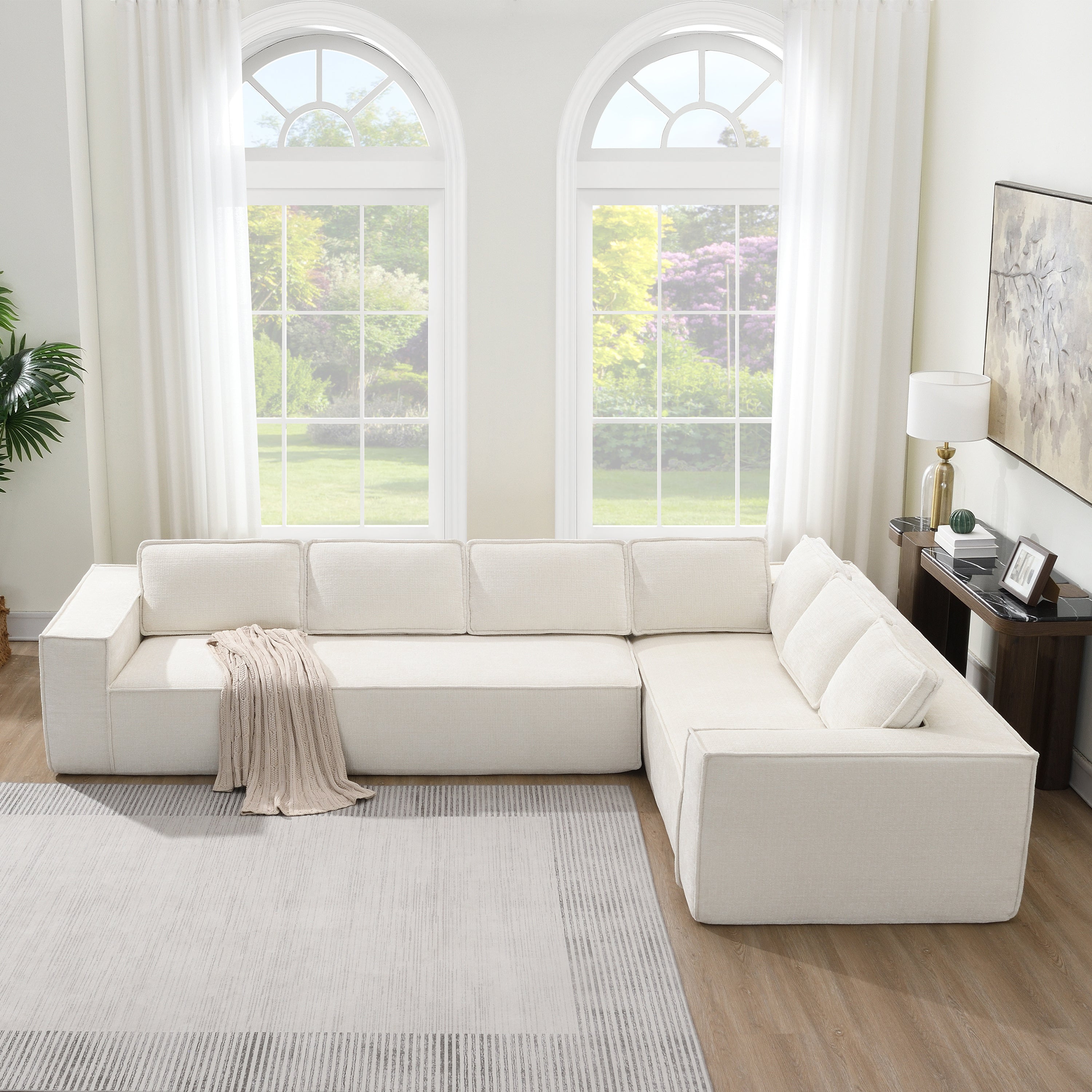 Chenille modular sectional sofa with minimalist design, styled in a modern living room with a soft throw blanket on the armrest.