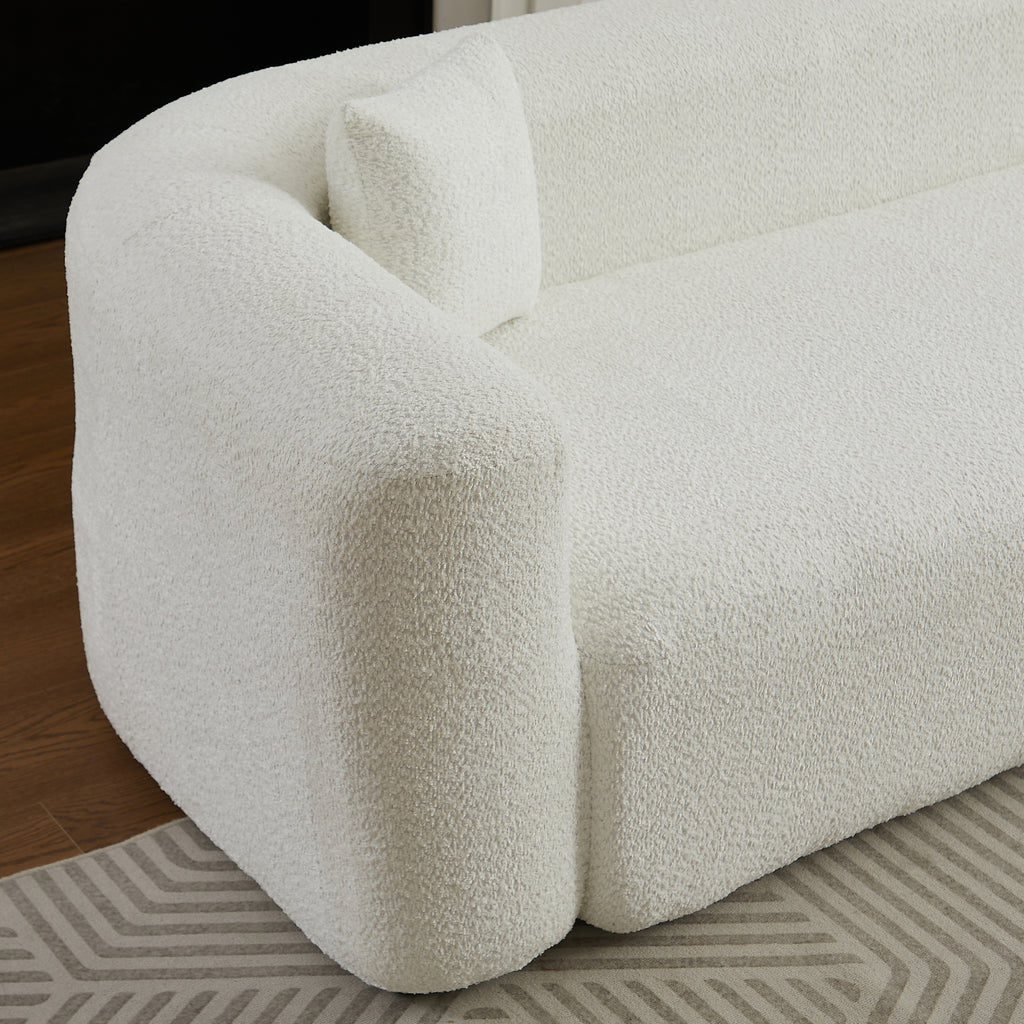 Close-up of the left armrest and cushion on the beige chenille modular sectional sofa, highlighting its rounded modern shape.