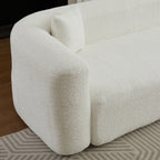 Close-up of the left armrest and cushion on the beige chenille modular sectional sofa, highlighting its rounded modern shape.