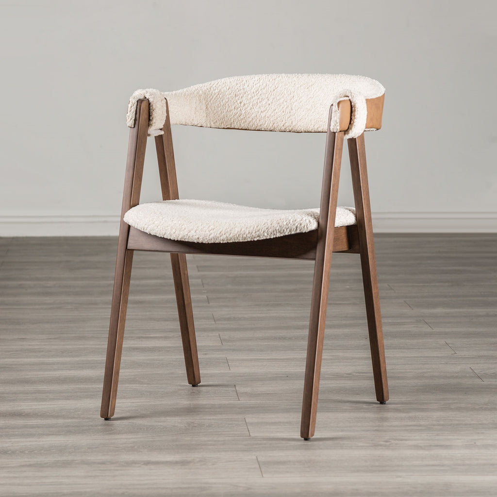 Single Mid-Century Modern Side Chair with beige boucle seat and walnut frame, showcasing minimalist design on a gray wood floor.