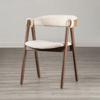 Single Mid-Century Modern Side Chair with beige boucle seat and walnut frame, showcasing minimalist design on a gray wood floor.