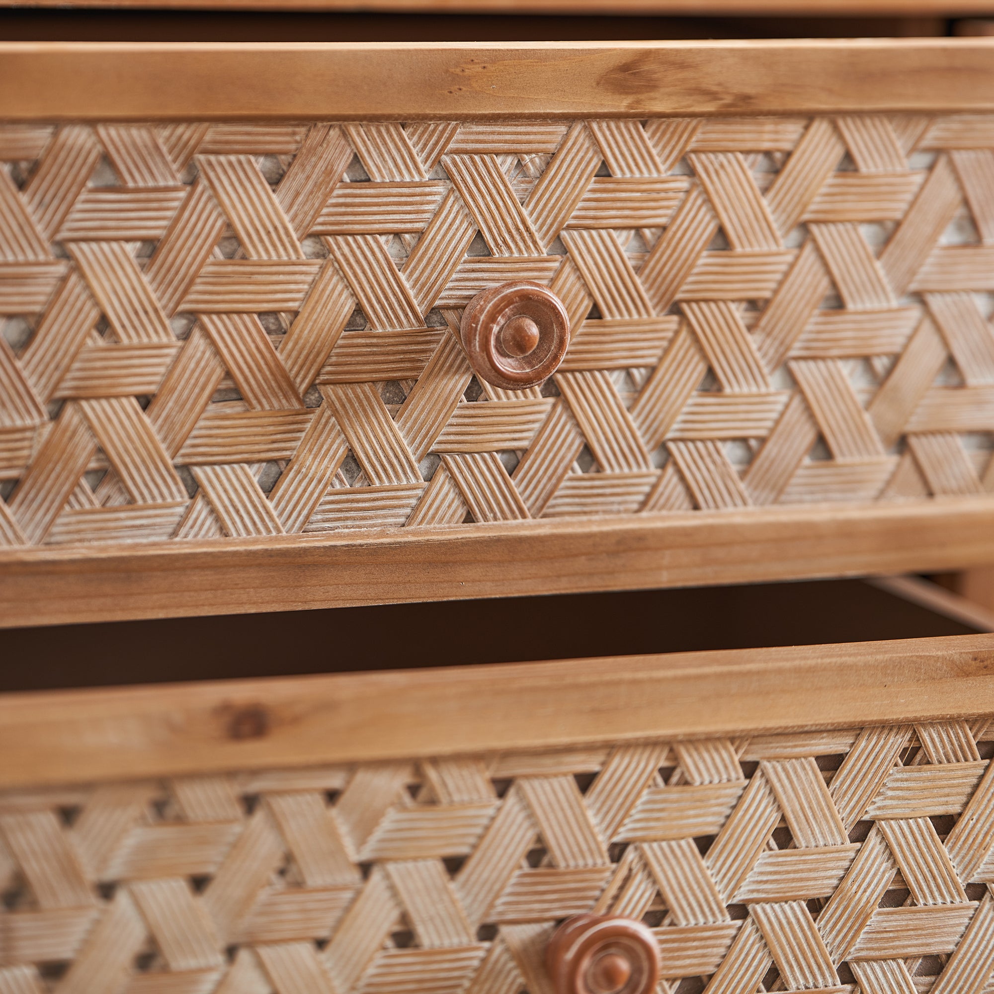 Close-up of rattan drawer fronts with round wooden knobs on the Mid Century TV Stand with Storage and Doors.