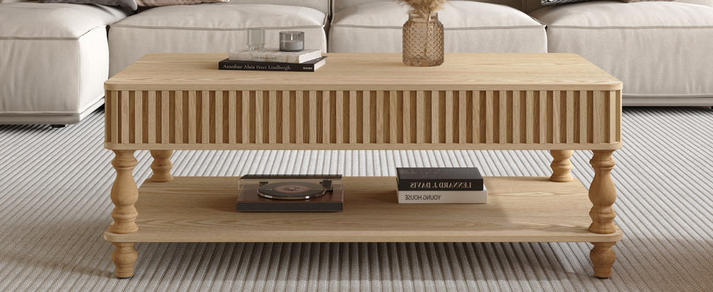 Closed lift top coffee table with visible lower shelf holding books and decor, crafted from solid wood with vertical fluted accents.