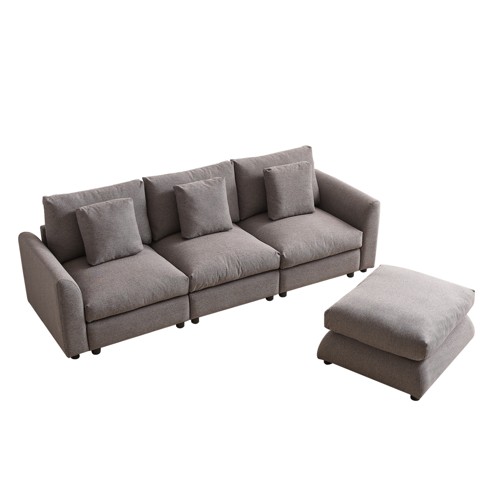 Gray upholstered modular sofa with detached ottoman, includes three seat cushions and four pillows, perfect for flexible home furniture arrangements.