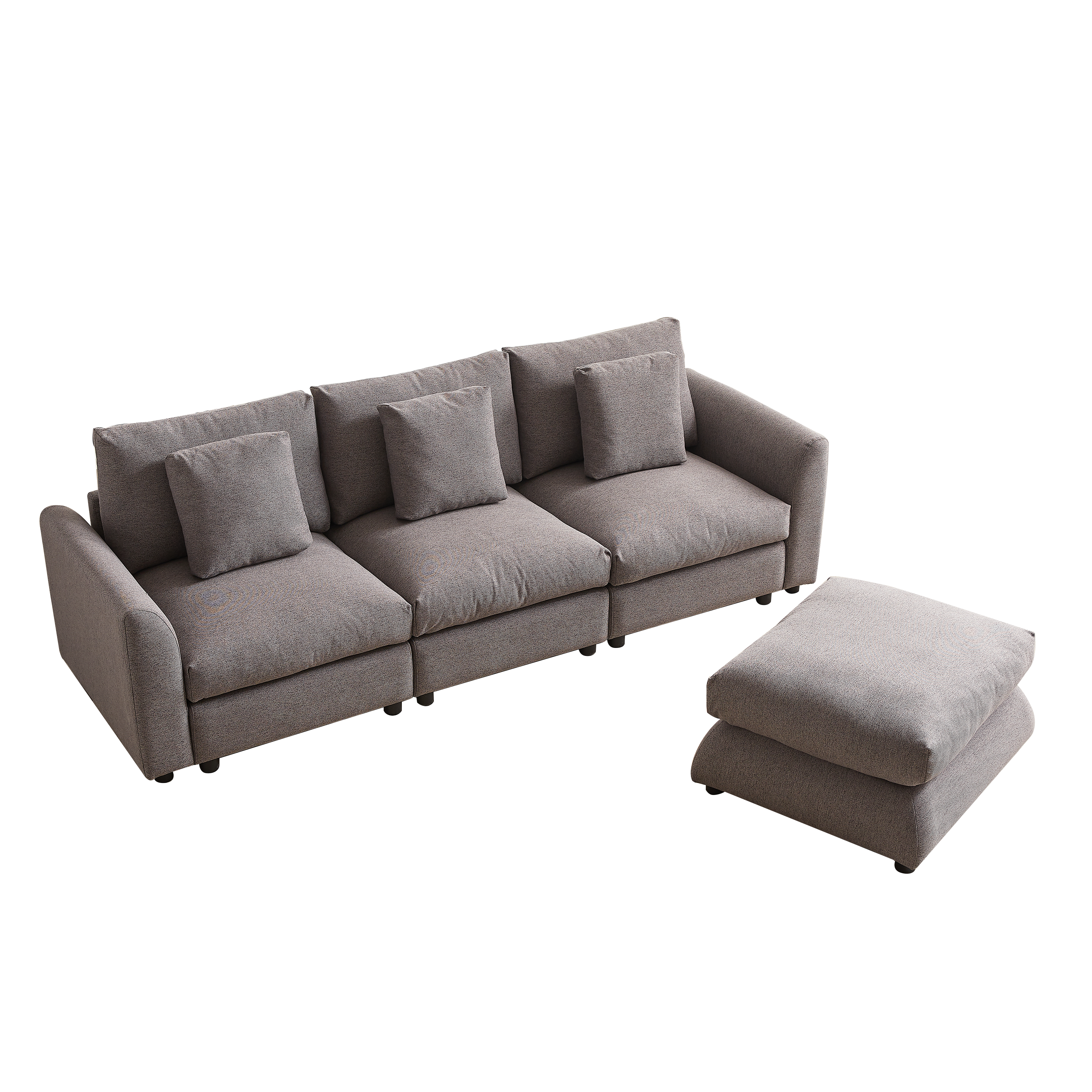 Gray upholstered modular sofa with detached ottoman, includes three seat cushions and four pillows, perfect for flexible home furniture arrangements.