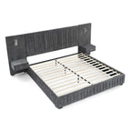 Queen upholstered bed with built-in bedside tables and adjustable lamps, featuring a solid frame and pleated headboard in dark gray fabric.