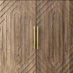 Detailed view of walnut sideboard doors with geometric wood grain and gold metal handles. Elegant design for modern dining storage.