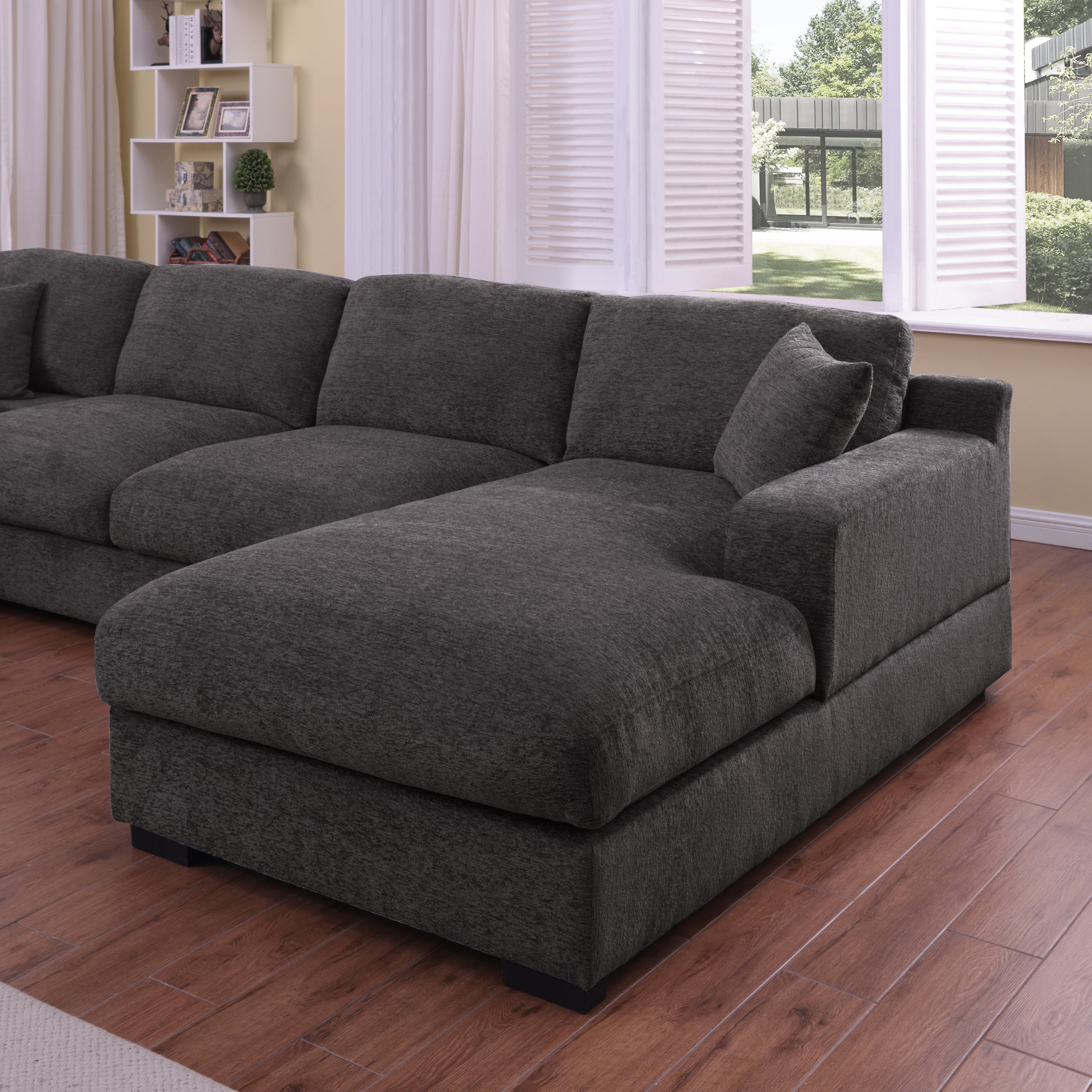 Right-facing chaise of gray chenille sectional sofa, highlighting plush seating and modern design for stylish living rooms.