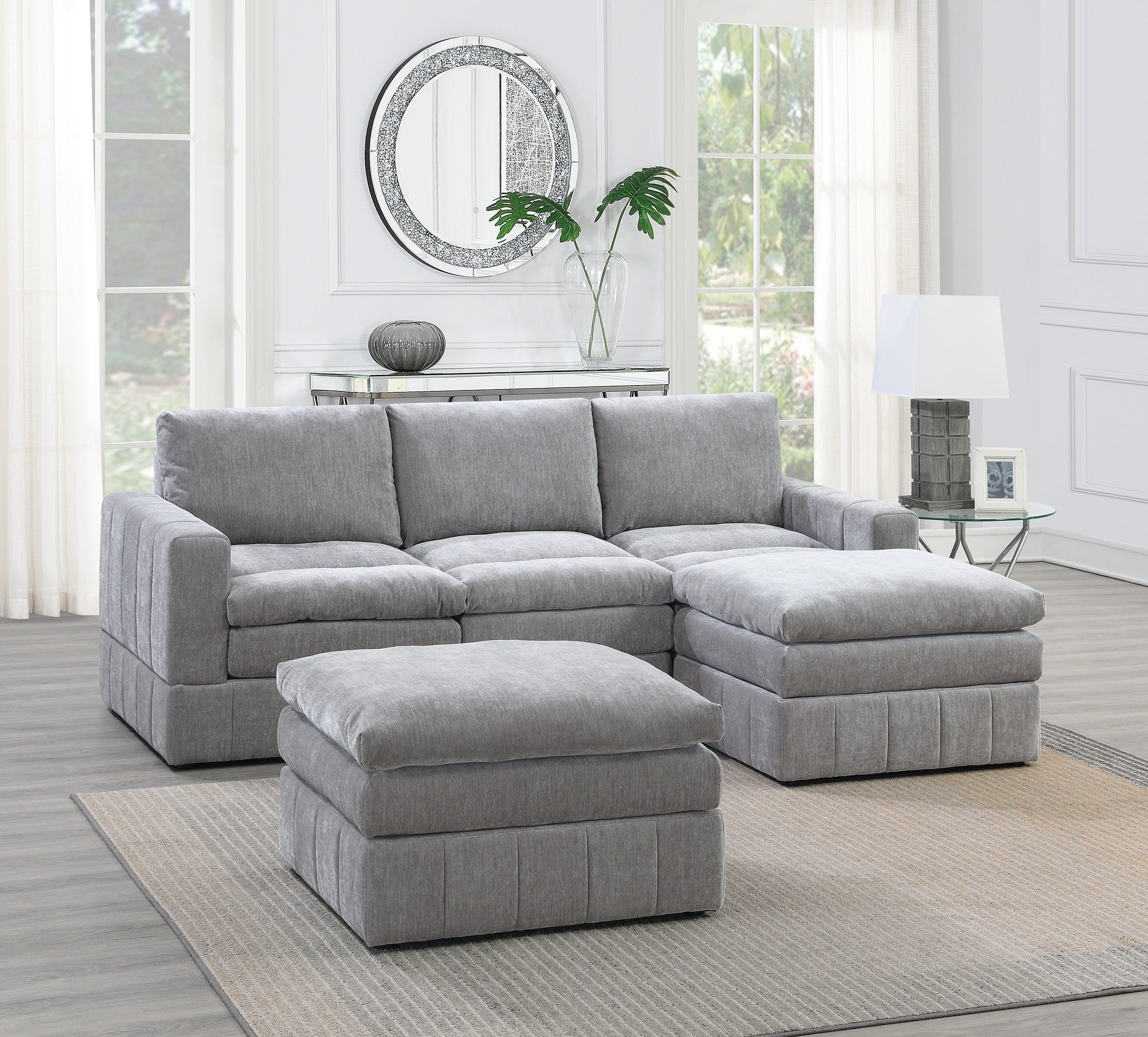Plush granite-colored modular sectional with two ottomans, featuring clean contemporary lines and soft fabric upholstery.