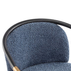 Detailed view of the curved backrest upholstered in blue fabric, supported by a sleek black metal frame for modern appeal.