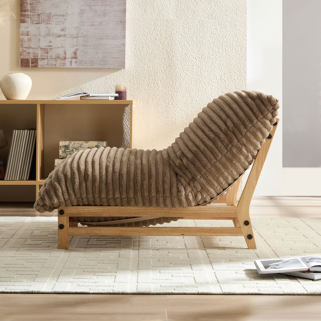 Side view of corduroy accent chair with curved backrest and wooden base, ideal for relaxing in a cozy living room.