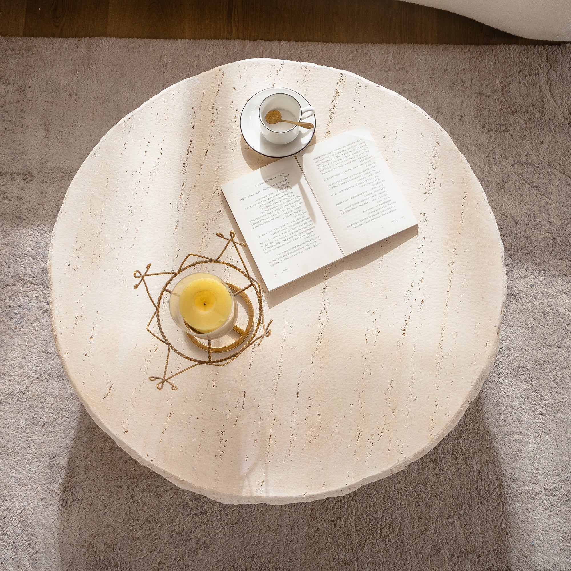 Top view of Mid-Century MgO Coffee Table showing smooth faux stone surface with a cup and book, ideal for stylish living room setups.