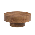 Round walnut burl wood coffee table with a modern pedestal base, featuring a rich, natural wood grain pattern.