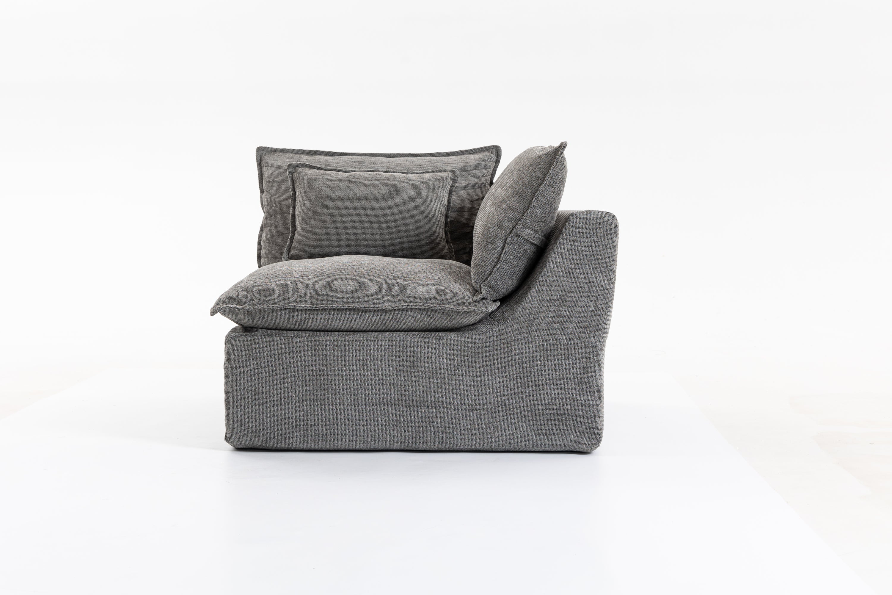 Side angle of the Cloud Couch modular sectional showing thick seat and back cushions in antique grey velvet.