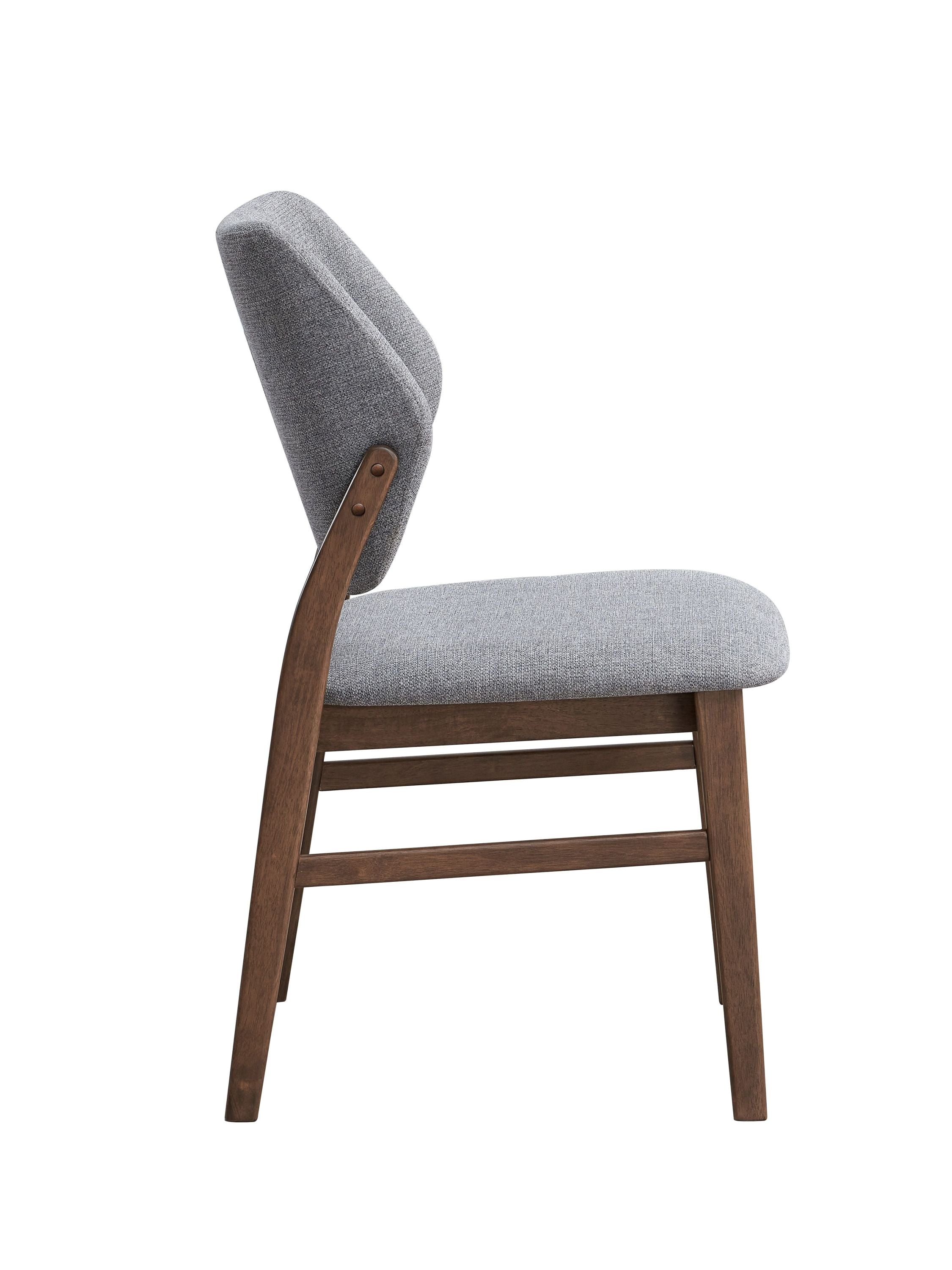 Side profile of Sarha dining chair showing padded seat and ergonomic backrest with walnut legs.