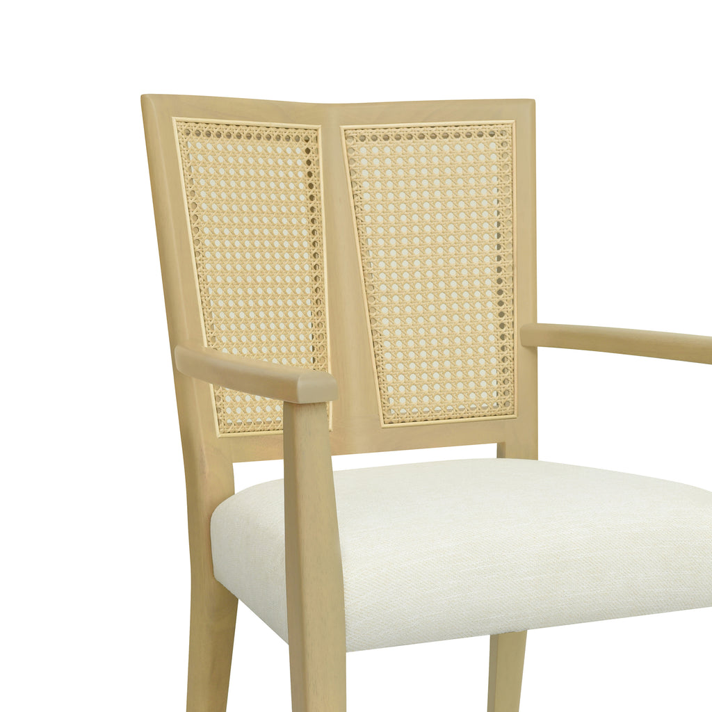 Close-up of rattan backrest and armrest design on mid-century modern dining chair, emphasizing craftsmanship and natural texture.