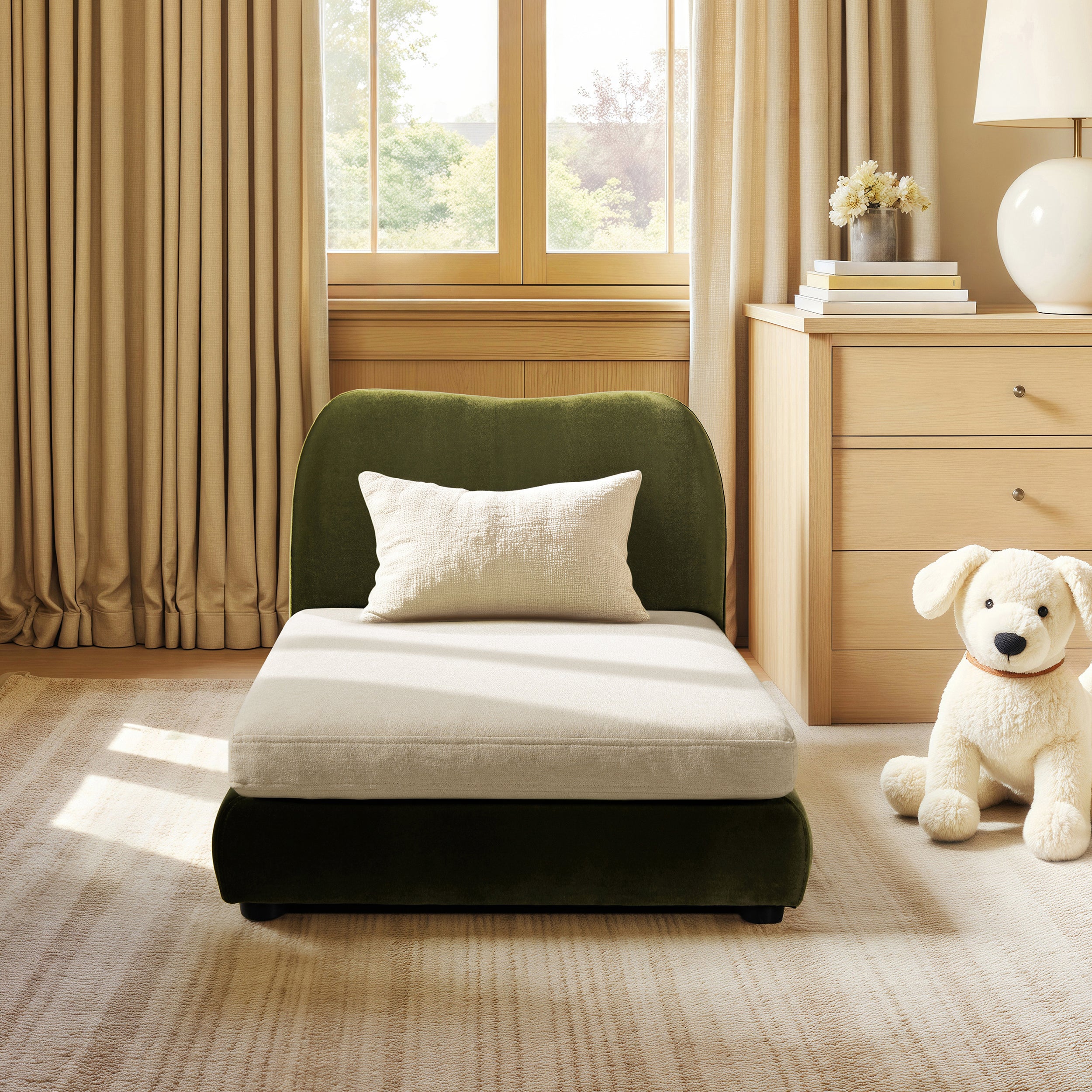 Modern olive green performance velvet pet sofa with a plush cream cushion and matching lumbar pillow in a cozy room.