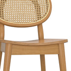 Close-up of brown rattan cane backrest and contoured beech wood seat, showcasing craftsmanship and eco-friendly materials.