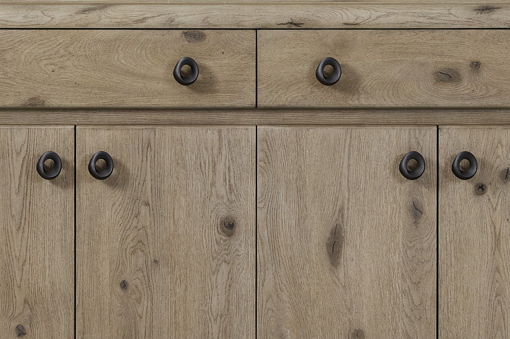 Close-up of Knotty Oak Veneer Server - English Style featuring natural wood grain texture and round black metal handles on drawers and cabinets.