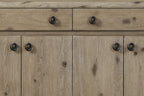 Close-up of Knotty Oak Veneer Server - English Style featuring natural wood grain texture and round black metal handles on drawers and cabinets.