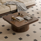 Close-up of walnut square coffee table showcasing parquet wood veneer top and thickened edges, styled with decor items.