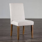 Rustic dining chair with white upholstered seat and backrest, featuring solid wood legs in a brown finish, ideal for cozy dining spaces.
