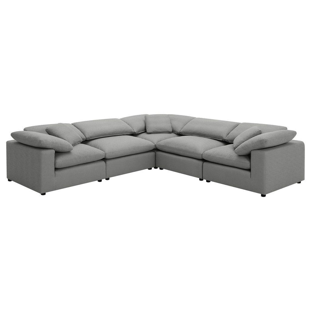 Grey 5-piece modular sectional in plush bouclé fabric, featuring deep seats, reclined back pillows, and low profile.