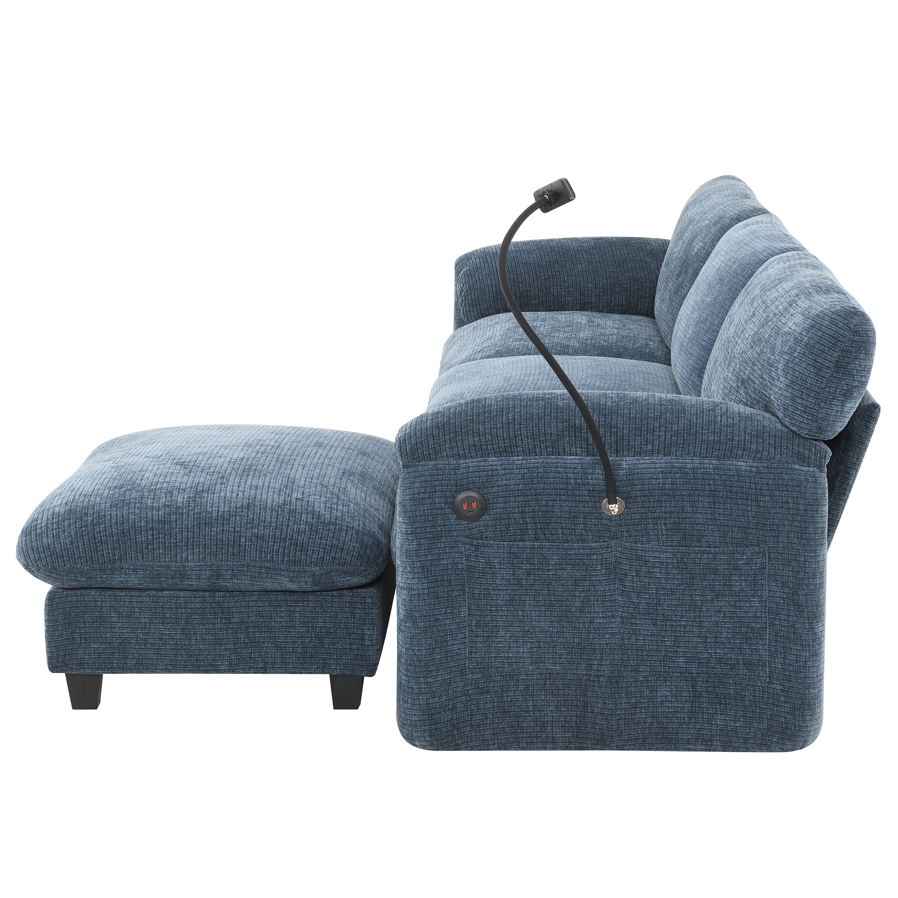 Side view of modular sofa with built-in USB charger and flexible reading light. Blue upholstered sectional with plush cushions and storage pocket.