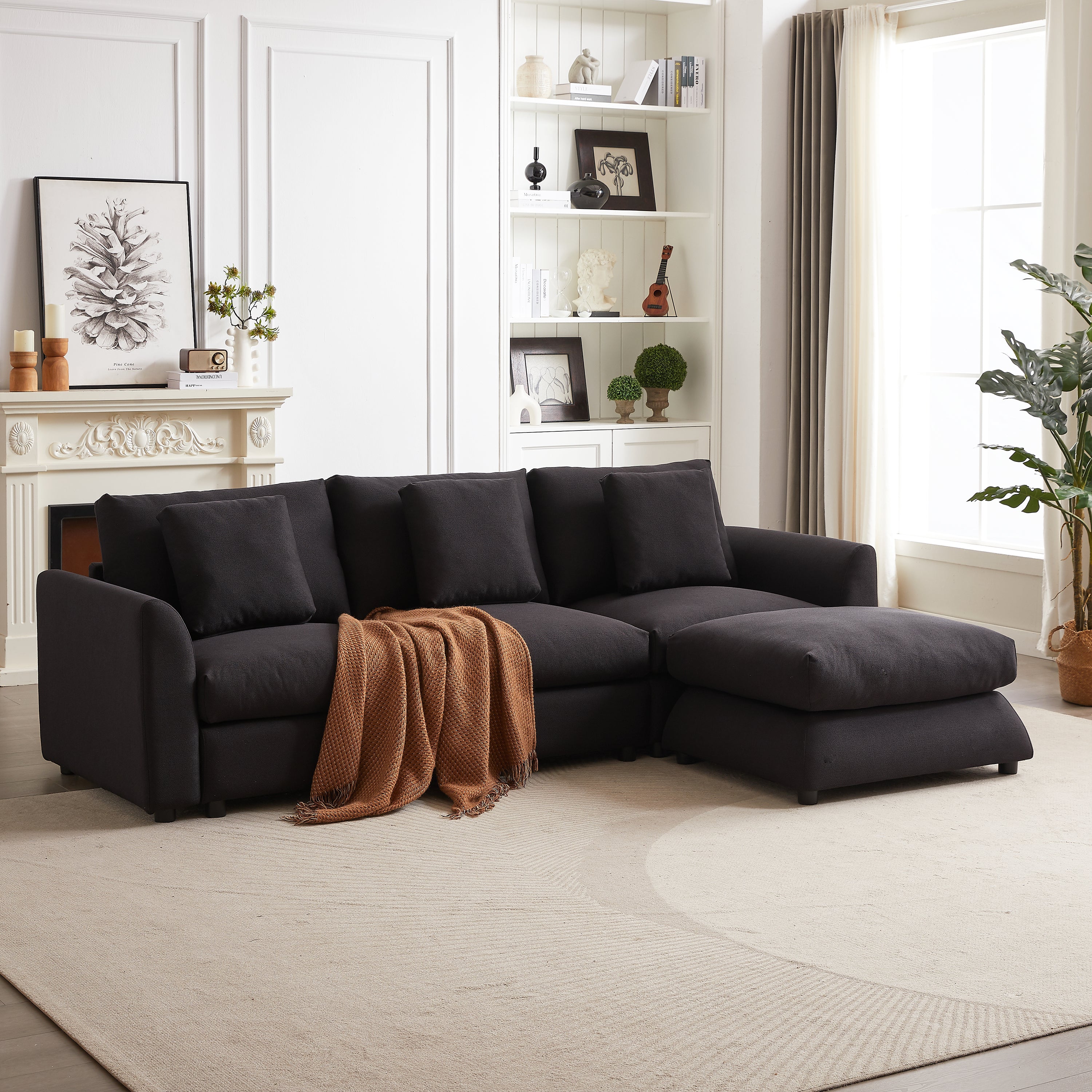 Modular L-shaped sofa with ottoman and throw blanket, offering a cozy and stylish seating solution for contemporary interiors.