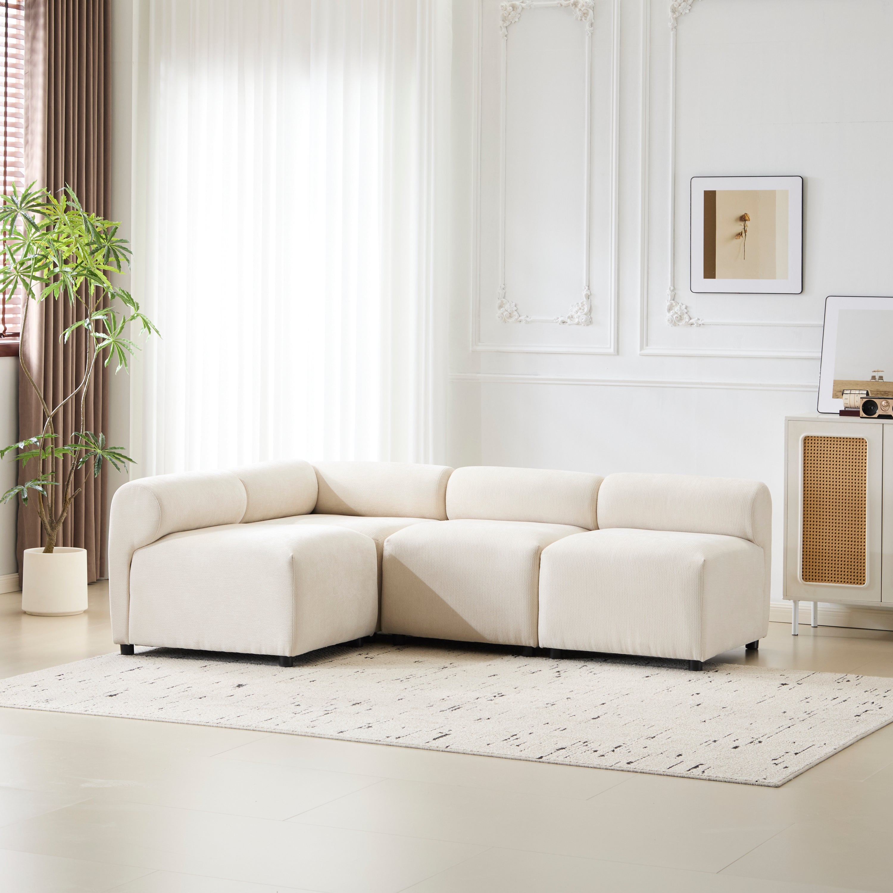Full view of the Evelyn L shaped chenille sectional couch in a bright living room, styled with a neutral rug and wall art.