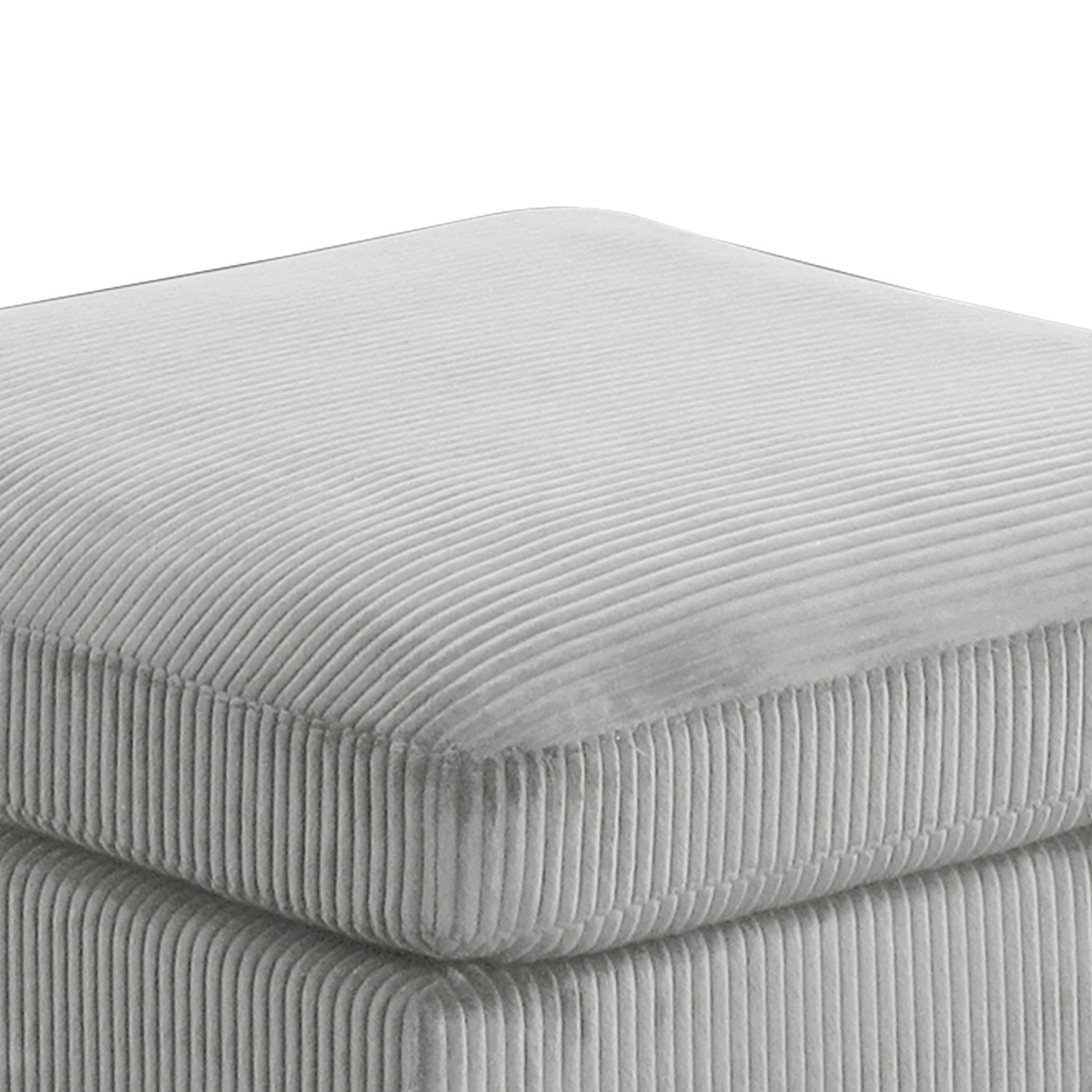 Close-up of Bentley Modular Sectional Sofa ottoman cushion in gray corduroy, highlighting soft ribbed fabric and thick padding.