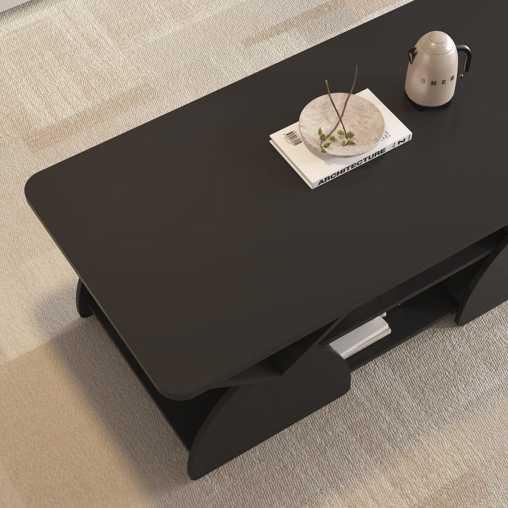 Top corner view of engineered coffee table with wood storage and sleek geometric design, styled with a tray and book.