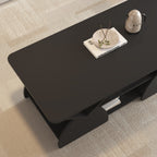 Top corner view of engineered coffee table with wood storage and sleek geometric design, styled with a tray and book.