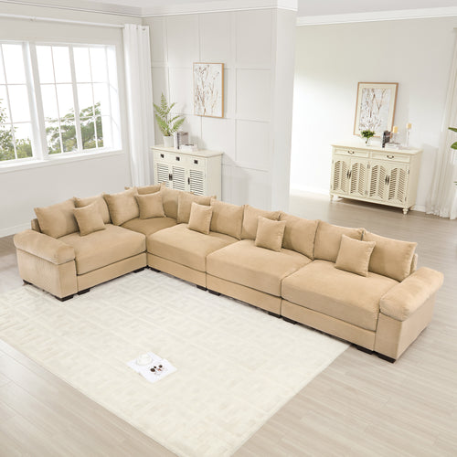 Oversized camel-colored corduroy modular sectional sofa with deep seats, wide armrests, and 16 matching throw pillows.