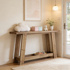 Narrow rustic wooden console table with a two-tier design, styled in a cozy entryway with decor accents.