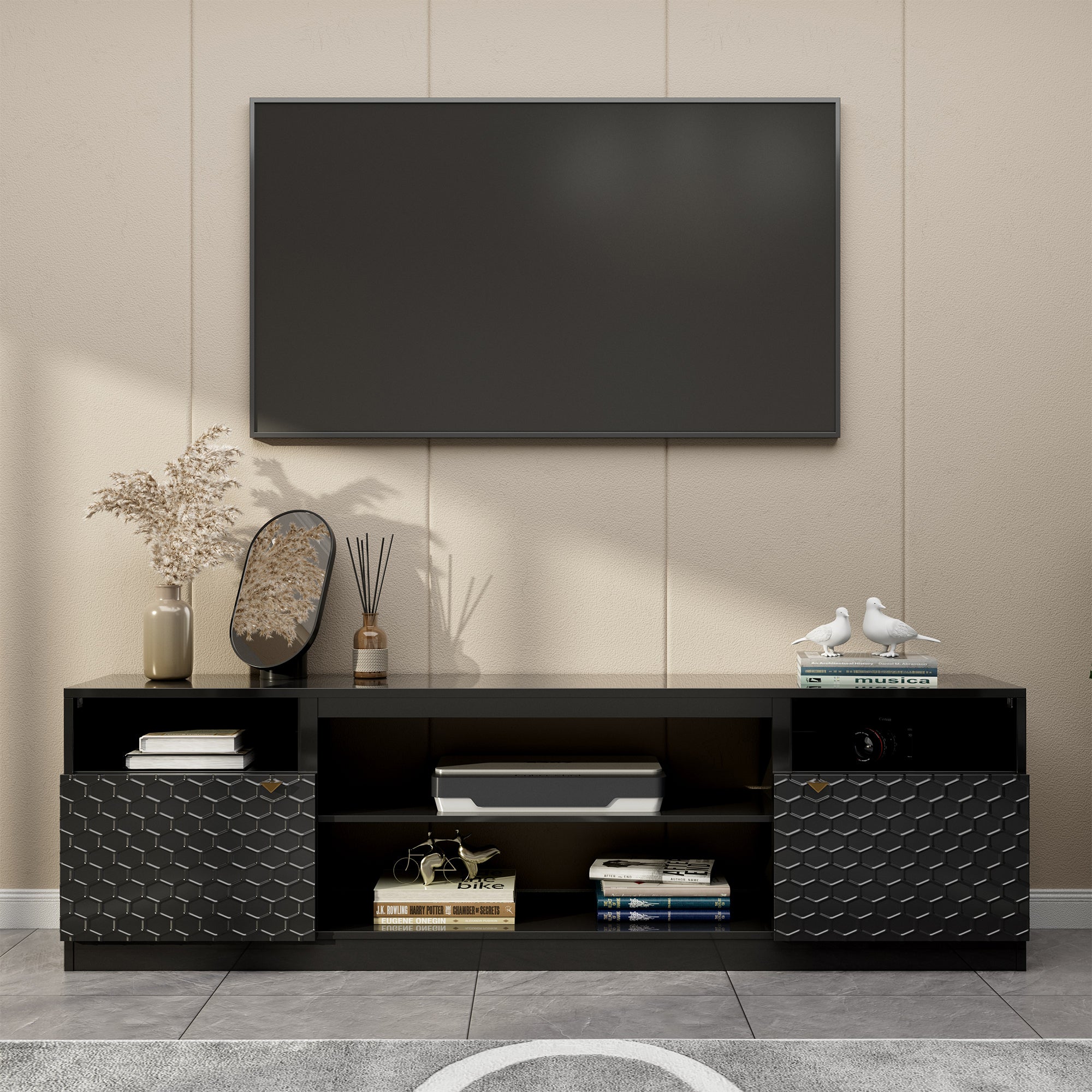 Modern black media console with textured geometric cabinet doors, open shelving, and surface space for large TVs.